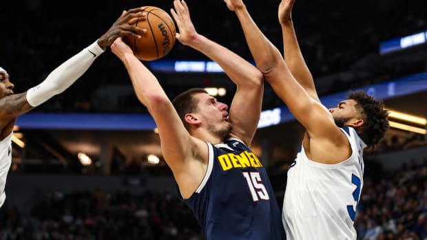 Nov 1, 2023; Minneapolis, Minnesota, USA; Minnesota Timberwolves forward Jaden McDaniels (3) blocks a shot by Denver Nuggets center Nikola Jokic (15) during the first half at Target Center.